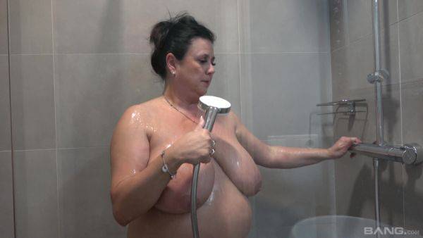 Busty nude mature showers and masturbates in a kinky combo on cooltits.com